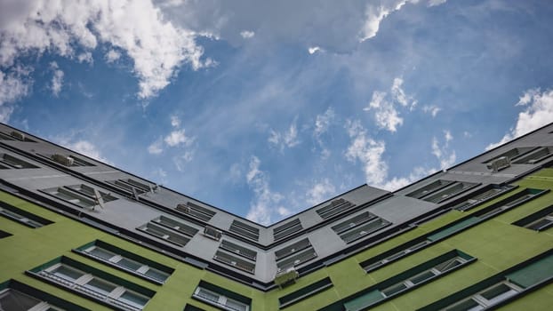 A timelapse of clouds in the background of an apartment complex