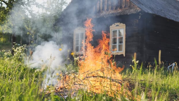 Burning branches outside the village house