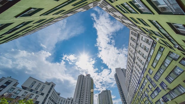 A timelapse of clouds in the background of an apartment complex