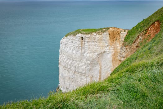 le treport with the big cliffs and green fields with the sea as background