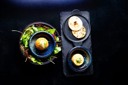 Closeup of some spanish croquettes in bed of lettuce served as tapas