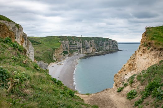 the chalk cliffs of le treport in France in Normandy with a blue sky with white clouds and the sea