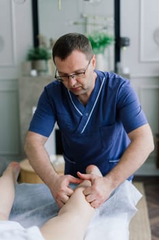 A woman receiving a belly massage at beauty salon