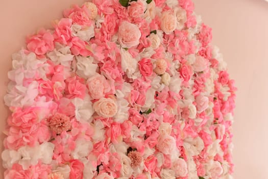 Artificial pink roses on the wall of a beauty salon