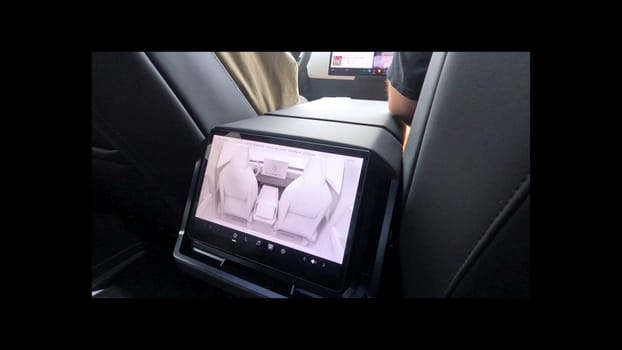 Denver, Colorado, USA-June 11, 2024-Slow motion-The interior view of a Tesla Cybertruck, showcasing its advanced dashboard and rear-seat screen. The modern and sleek design emphasizes Tesla innovative technology and luxury features.