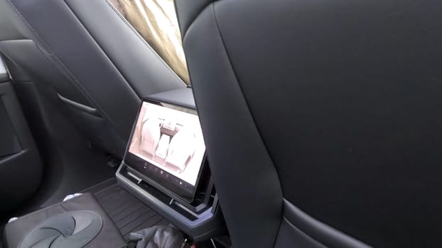 Denver, Colorado, USA-June 11, 2024-Slow motion-The interior view of a Tesla Cybertruck, showcasing its advanced dashboard and rear-seat screen. The modern and sleek design emphasizes Tesla innovative technology and luxury features.