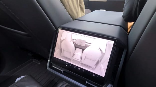 Denver, Colorado, USA-June 11, 2024-Slow motion-The interior view of a Tesla Cybertruck, showcasing its advanced dashboard and rear-seat screen. The modern and sleek design emphasizes Tesla innovative technology and luxury features.