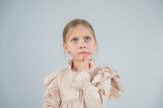 Portrait of a cute Caucasian pensive girl on a white background