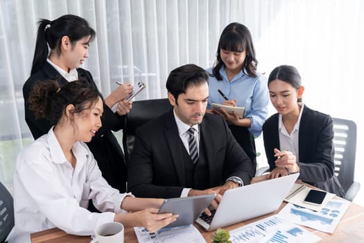 Diverse group of business analyst team analyzing financial data report paper on office table. Chart and graph dashboard by business intelligence analysis for strategic marketing planning Meticulous