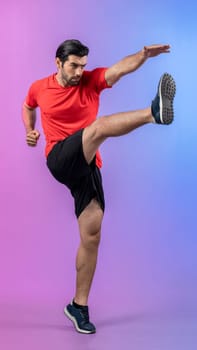 Full body length gaiety shot athletic and sporty young man with fitness in cardio exercise, kicking position posture on isolated background. Healthy active and body care lifestyle.