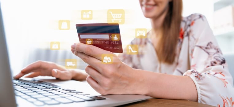 Elegant customer wearing floral shirt holding credit card choose online platform. Smart consumer typing laptop while open e-commerce application use cashless technology shopping inventory. Cybercash.