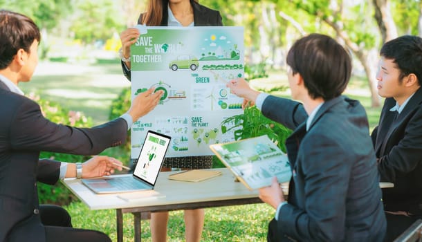 Group of asian business people presenting environmentally friendly development plan and sustainable technology project for greener future, establishing outdoor eco business office at natural park.Gyre