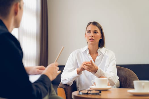 Psychological consultation gaining improvement on mental problem, happy young female patient doing therapy session while psychiatrist making diagnostic on mental illness. Unveiling