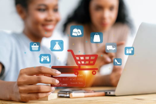 Customer hold credit card with hologram graphic interface of program. Client point laptop consulting another user open e-commerce application use cashless technology shop online inventory. Cybercash.
