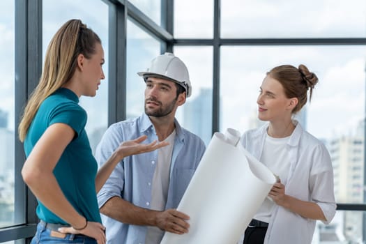 Group of architect engineer looking at project plan while brainstorming idea about building structure. Manager team discuss about building construction while standing near with city view. Tracery.