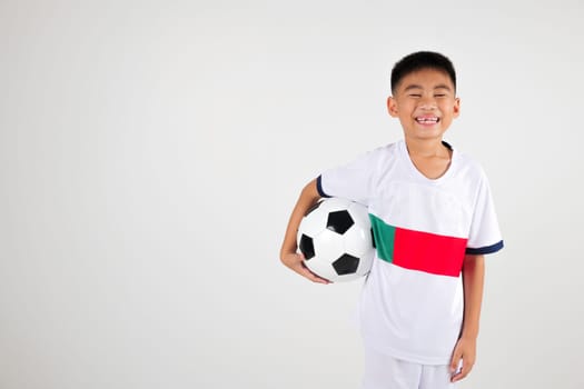 Portrait Asian smiling young boy kids holding soccer ball studio shot isolated white background, celebrating happy cute child player football, sport hobby for kids, leisure games