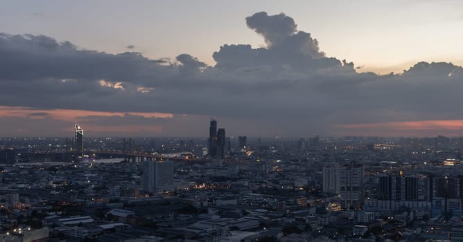 Bangkok, Thailand - 15 Jun, 2024 - Aerial view of skyscrapers and dramatic sky before sunset. Beautiful clouds in the sky over large metropolitan city of bangkok, Space for text, Selective focus.
