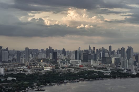 Bangkok, Thailand - 20 Jun, 2024 - Amazing clouds in the sky over large metropolitan city of bangkok along Chao Phraya riverside. Aerial view of skyscrapers and dramatic sky before sunset, Copy space, Selective focus.