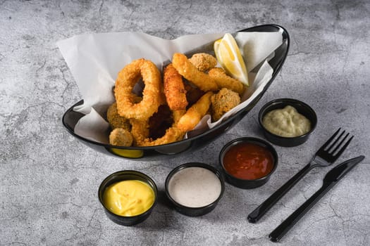 Deep fried squid, shrimp and mussels with sauces on the side