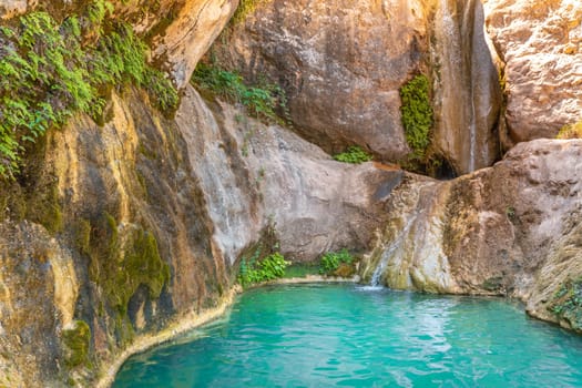 Turquoise blue crystal clear water in the river with a waterfall summer vacation relaxing body and mind background. High quality photo