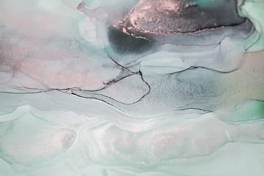 A close-up view of an abstract painting featuring swirling blue and gold hues against a white background. The artwork resembles a sky, water, or other natural element.
