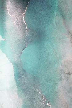 A close-up shot of an abstract painting with swirling shades of blue and gold, creating a mesmerizing and artistic visual.