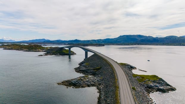 An aerial view of the Atlantic Road bridge in Norway, a scenic route with a unique design that runs through the ocean.