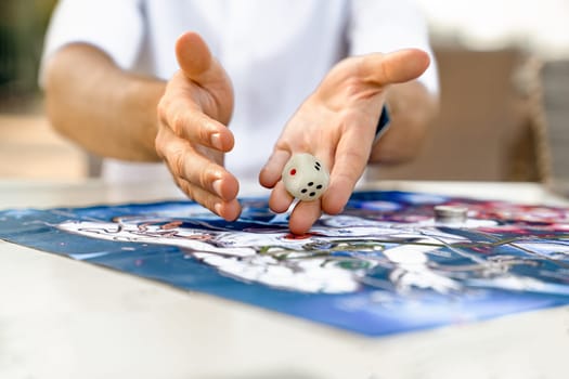 Man's Hands Close-Up Throwing Die on Playing Field of Leela's Game for Self-Discovery, Turkey, Alanya - April 14, 2024