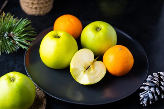 Fresh ripe green apples on a wooden table against dark background, space for text