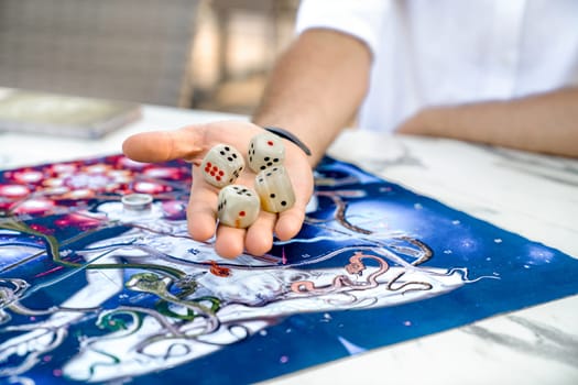 Men's Hands Close-Up with Onyx Dice Zar on Game Board from Ancient Indian Game Leela, Turkey, Alanya - April 14, 2024