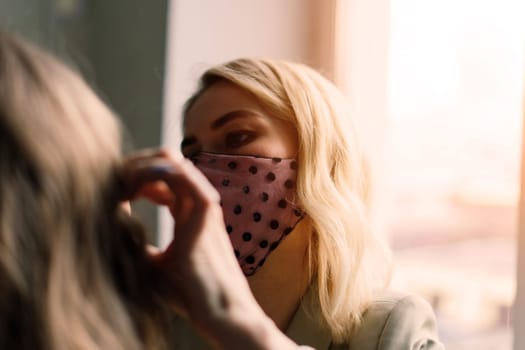 Makeup artist applies lipstick. Hand of make-up master, painting lips of a young beauty model.