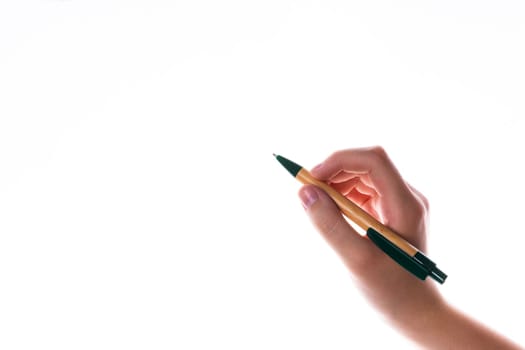 Children hand with pen write on a blue white background. Writing hand.