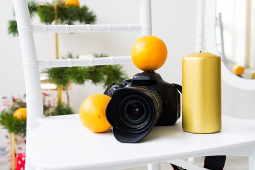 Photographer's equipment with Christmas decor on a white chair