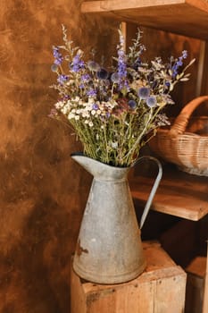 bouquet of dried flowers in a pink vase Azurite