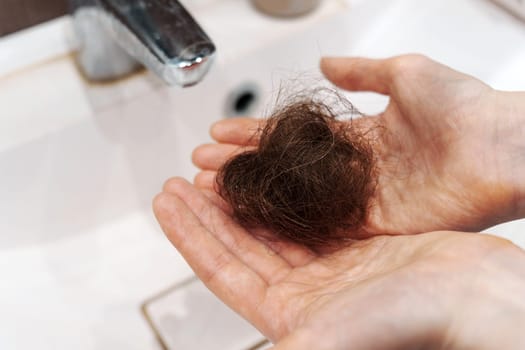 Hair clump from the shower drain. Cleaning or hair loss concept.