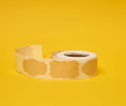 Sticky empty brown paper labels on tape, yellow background