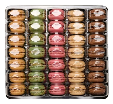 Assortment of macarons in a square plastic box with a transparent lid on an isolated background, top view