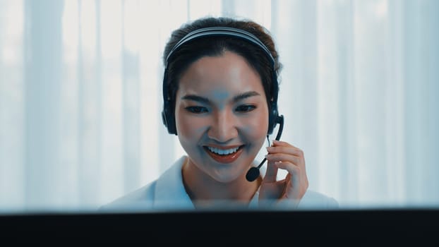 Businesswoman wearing vivancy headset working in office to support remote customer or colleague. Call center, telemarketing, customer support agent provide service on telephone video conference call