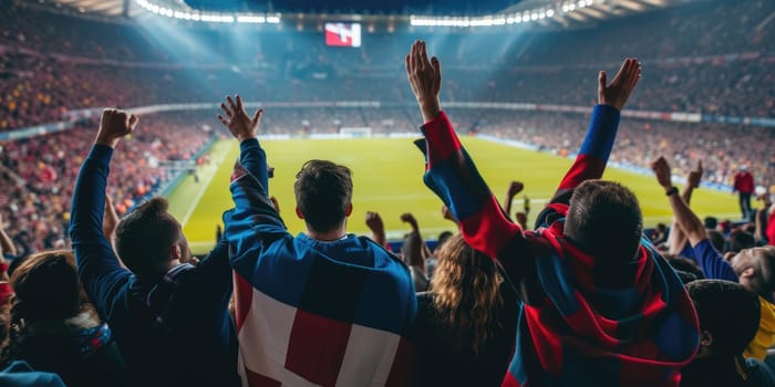 A crowd of fans at a competition event in a stadium, with arms in the air, sharing the fun and entertainment of watching a soccer game. AIG41