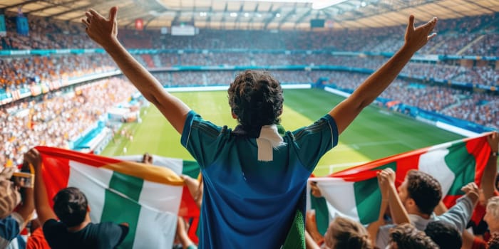 A fan at a soccer match joyfully celebrates a thrilling event, raising his arms in excitement. The Cup match provides entertainment and fun for leisure seekers. AIG41