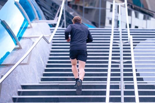 Man running down the stairs doing his daily cardio and warm-up exercise. Concept of Physical Activity