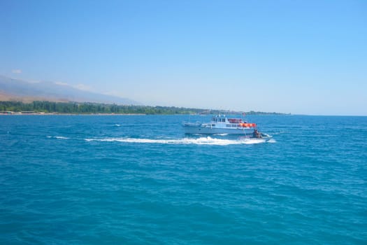 Jet ski in the sea on a Sunny day on the handicap of a small motor ship
