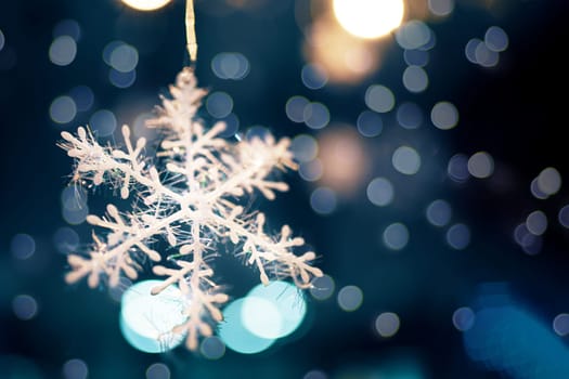Decorated Christmas tree. Decorated Christmas snowflake on blurred, sparkling and fairy background. Close up.