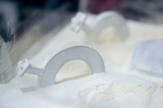 White polyamide powder and object on 3D printed from white polyamide powder close-up. Polyamide powder for creating objects on 3D printer. Additive MJF Multi Jet Fusion technologies. Thermoplastic