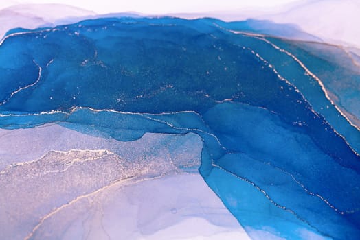 A close-up shot of an abstract painting with swirling shades of blue and gold, creating a mesmerizing and artistic visual.