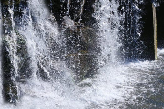 The stream and splashes of a rapidly falling waterfall.