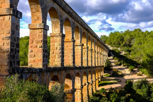 Roman aqueduct. Old stone bridge. Spain . High quality photo