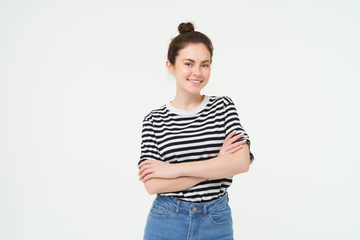 Image of charismatic young woman in striped t-shirt and jeans, looking confident and happy, smiling at camera, candid emotions, white background.