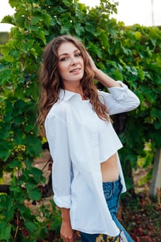 portrait of woman in white clothes in nature in vineyards