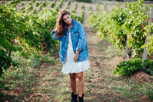 woman in denim clothes in vineyards walk nature